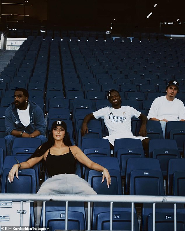 In another photo, she sat in the empty stands with the boys, Junior and her two friends, with her arms and legs spread wide in a powerful pose.