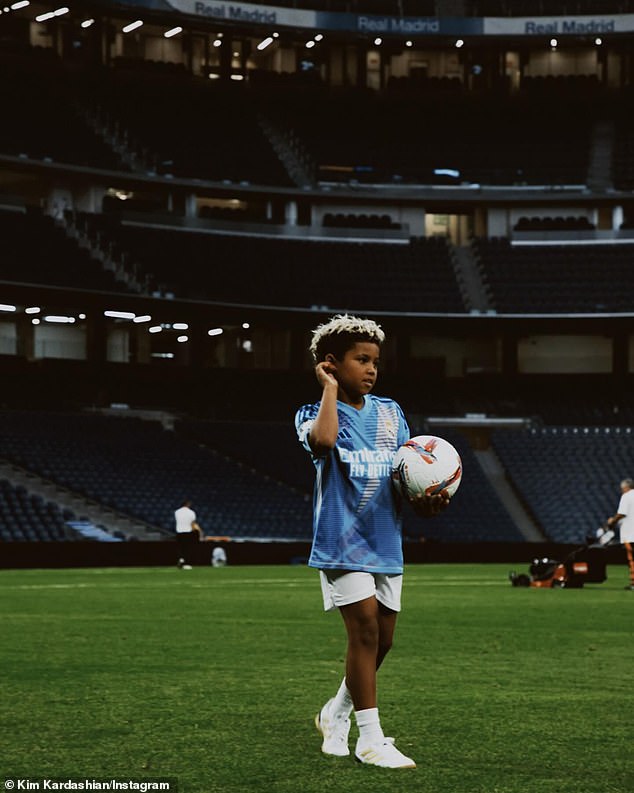 She shared a snapshot of Saint holding a football and playing on the field in an empty stadium