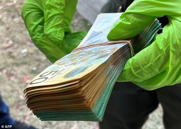 A 34-year-old man and a 33-year-old woman were sentenced to four years and two years in prison respectively on Friday after putting shimmers on ATMs (money is pictured found on their property)