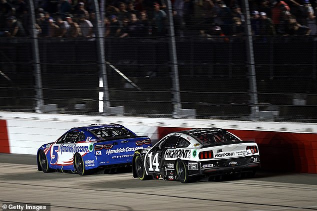 Kyle Larson, driver of the #5 HendrickCars.com Chevrolet, and Chase Briscoe, driver of the #14 HighPoint.com Ford, race during the NASCAR Cup Series Cook Out Southern 500