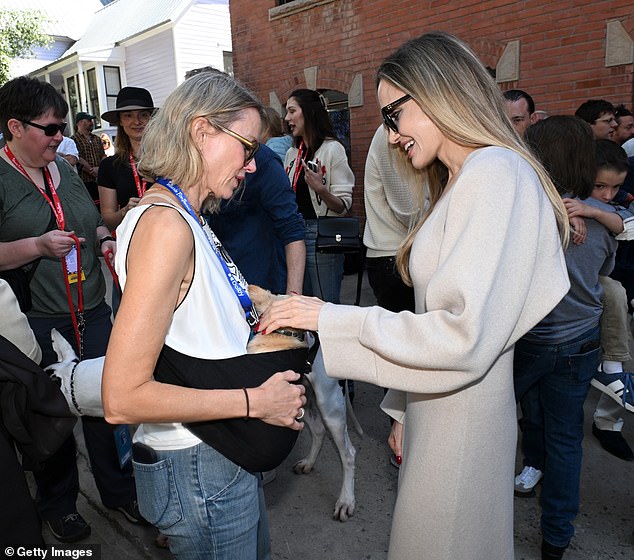 The mother of six was seen petting a small dog that Naomi was carrying in a sling