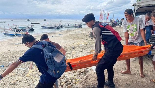 Ms Phillips collapsed just minutes after emerging from the water. She reportedly suffered from shortness of breath (Photo of rescuers and first responders at the scene)