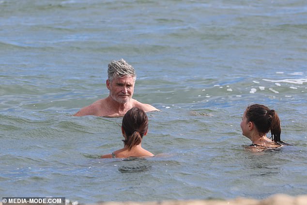 Melbourne's frigid temperatures didn't stop the comedian from stripping down to a pair of board shorts and taking a dip with his wife Holly and children Rafferty, 15, Sadie, 13, and Tess, 11.