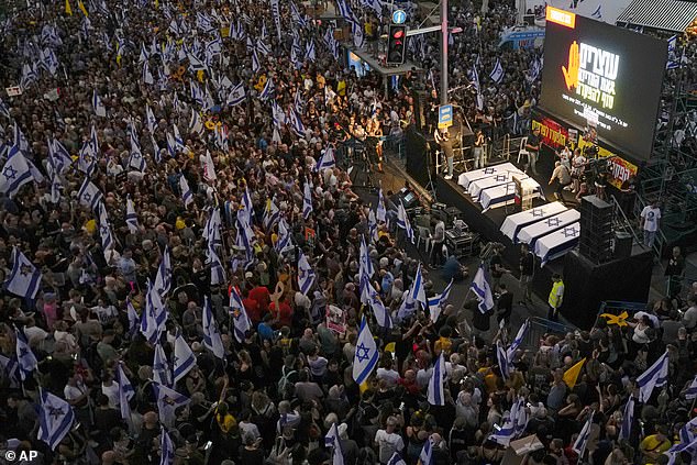 People take part in a protest in Tel Aviv, demanding a ceasefire