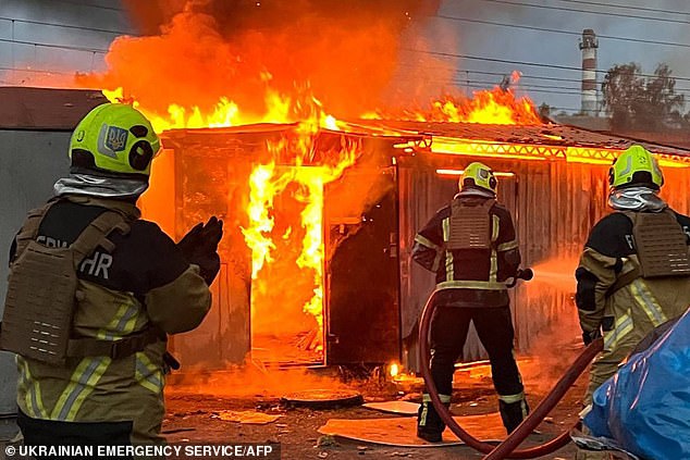 This handout photo, taken and released by the Ukrainian Emergency Service on September 2, 2024, shows rescuers working to extinguish a fire after a rocket attack in Kiev.