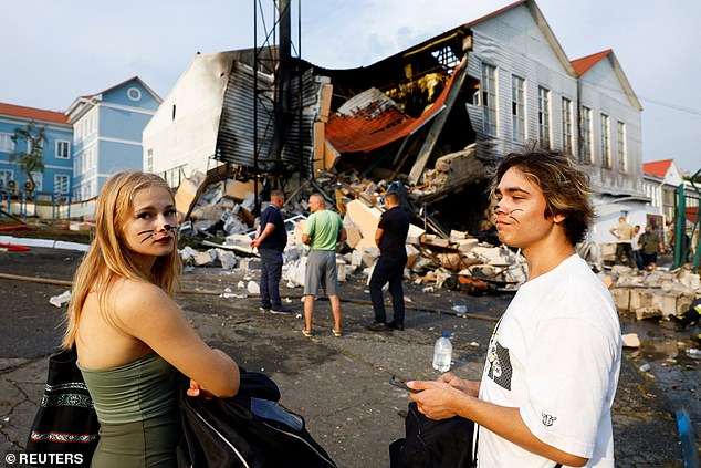 Students who came to celebrate the start of the school year stand at the damaged sports complex of a university that was damaged by a Russian missile attack, amid the Russian-Ukrainian conflict, in Kyiv, Ukraine, September 2, 2024