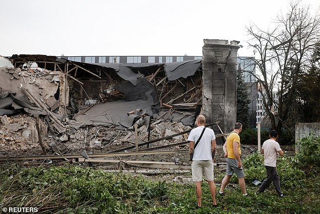 People look at the damaged site of the Russian missile attack on an office building, amid the Russian-Ukrainian conflict, in Kiev, Ukraine, September 2, 2024