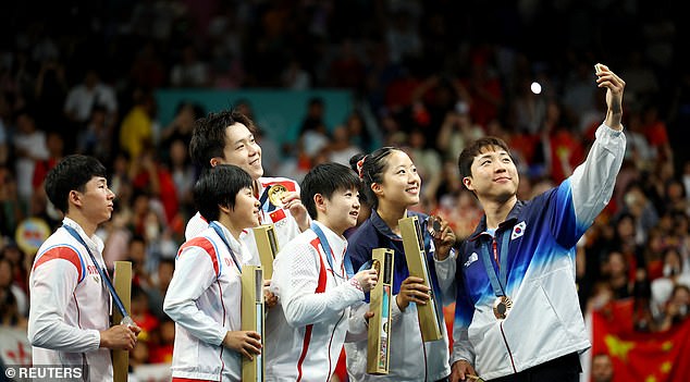 Kim Kum-yong took the selfie with a smile, while Ri Jong-sik was seen grinning as they showed off their medals on the Olympic podium