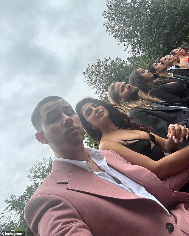 The two certainly weren't camera shy, as the Jonas Brothers member even snapped a selfie of him and his wife as they sat during the outdoor ceremony