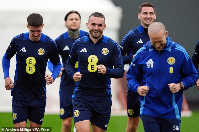 John McGinn warms up with his teammates ahead of Thursday's match against Poland