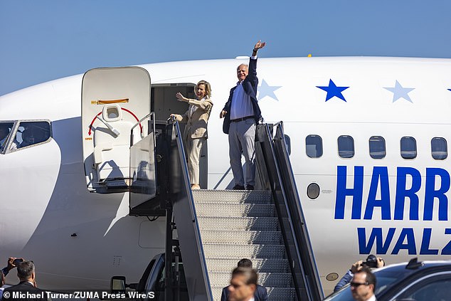 Tim Walz and his wife Gwen Walz wave before boarding a campaign plane