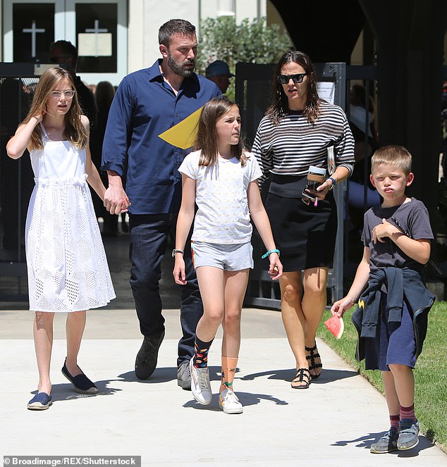 Fin is pictured here in 2019 with their older sister Violet (left), now 18, and younger brother Samuel (right), now 12