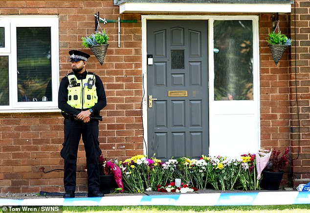 A police officer stands guard outside the home where Jahziah Coke was murdered on Thursday