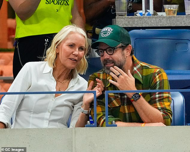 Australian tennis coach Rennae looked stylish in a textured white shirt further accented with a layer of gold chains as she chatted with Jason in the stands