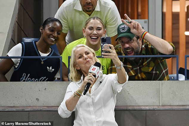 The Australian tennis coach looked stylish in a textured white shirt and layered gold chains as she snapped a selfie with Jason