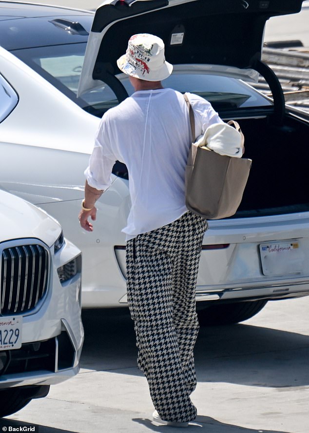 Brad looked relaxed and happy as he walked, with the star completing his travel outfit with a simple white top, dark sunglasses and trainers