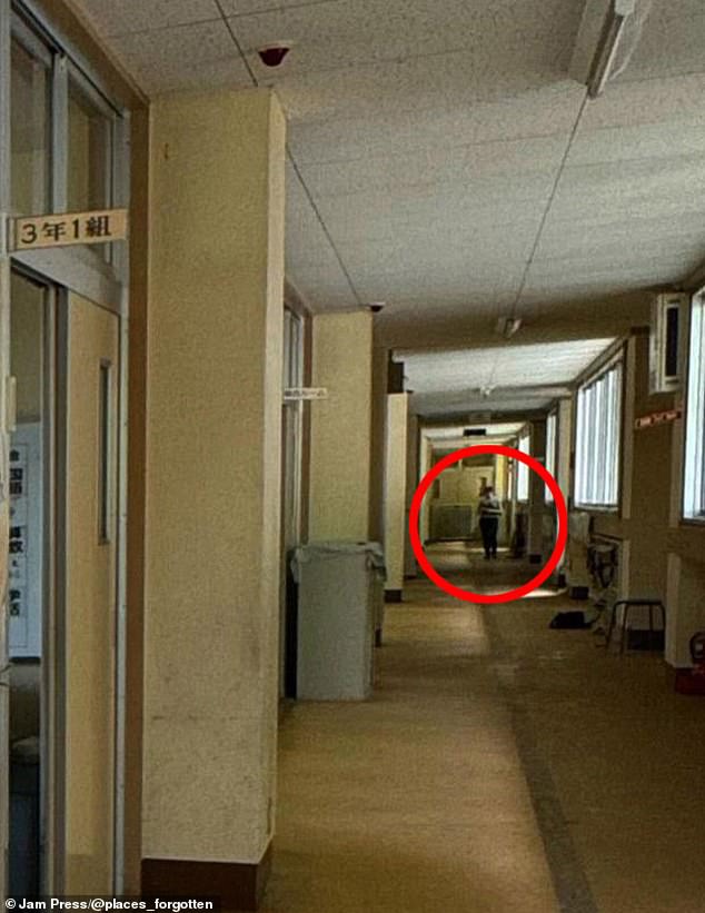 A chilling image shows a figure lurking in the shadows of an empty hallway