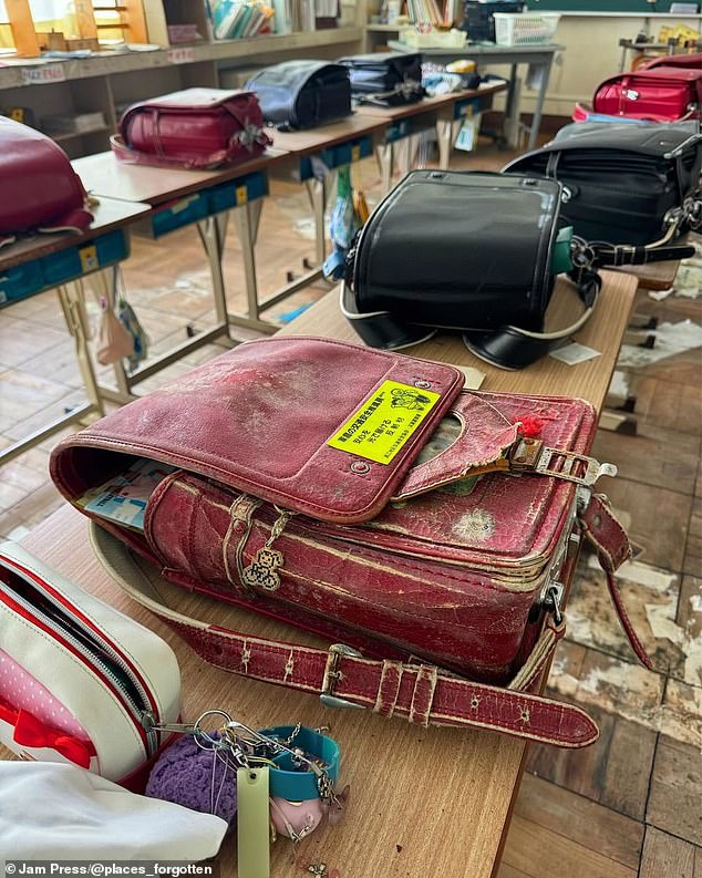 The school was abandoned in 2011 and has been frozen in time. The image shows school bags on tables that have been untouched for over 10 years