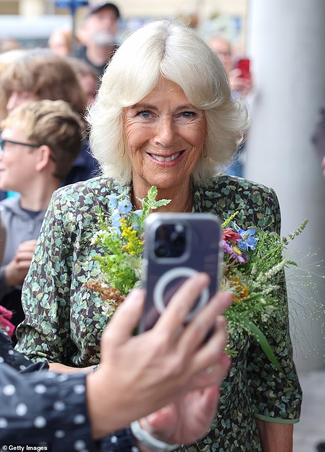 The Queen wore her hair in a sleek blow-dry and wore glamorous jewellery including a Van Cleef bracelet and a friendship bracelet – which has proven to be a popular royal accessory of late