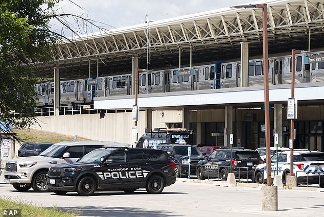 Police cars from the Elmwood Park Police Department, Berwyn Police Department and Cicero Police Department are parked in the parking lot of the Forest Park Blue Line train station in Forest Park, Illinois, after four people were fatally shot on the train early in the morning of Monday, September 2, 2024.