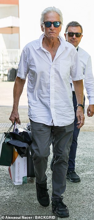 Michael Douglas looked stylish as always in a white shirt and gray pants