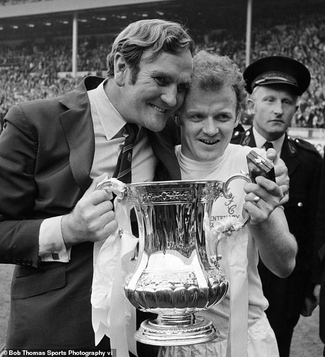 Leeds captain Bremner proudly displays the FA Cup with manager Don Revie