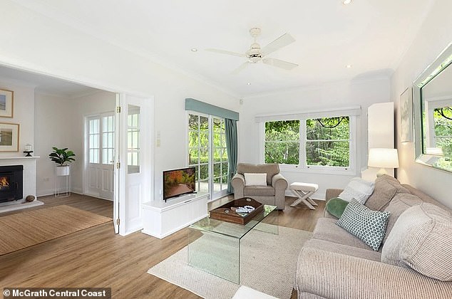 Highlights include a backyard entertainment deck hidden under a vine-covered alcove and a saltwater pool. Pictured: One of the main living areas