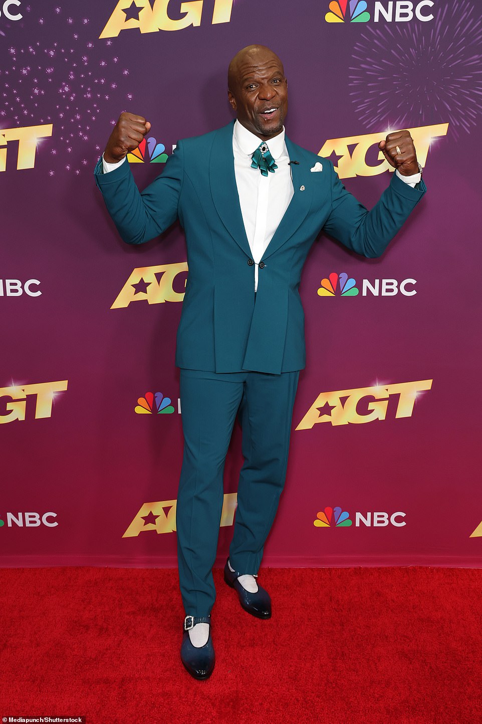 Host Terry Crews showed off his muscular physique in a fitted green suit with matching tie and a crisp white shirt.