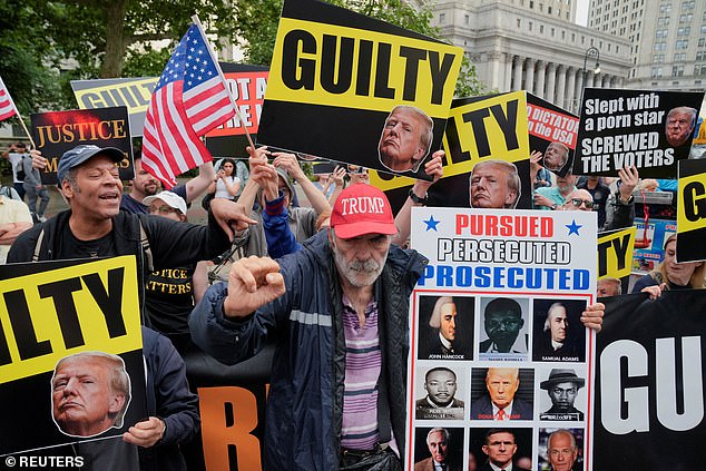 Protesters hold banners and flags outside the Manhattan Criminal Courthouse in May