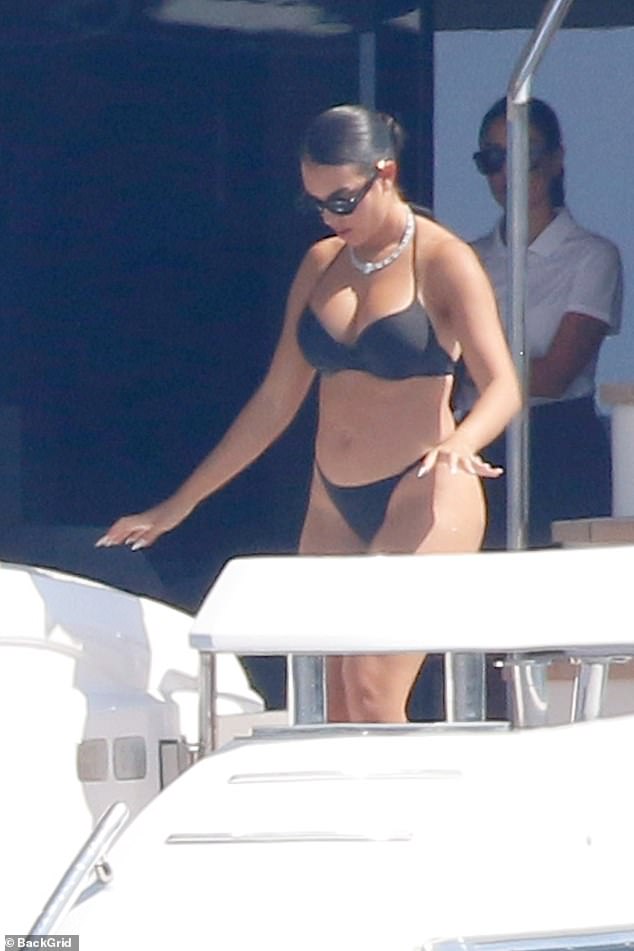 Georgina showed off her figure in a black bikini, with the thong bottoms accentuating her curves