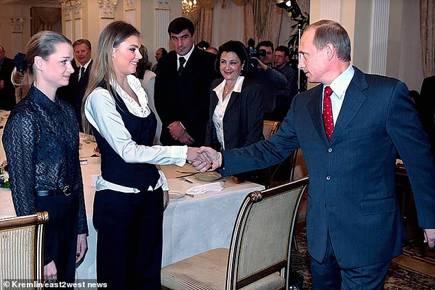 Kabaeva shakes hands with Putin during a meeting with gymnasts in the Kremlin