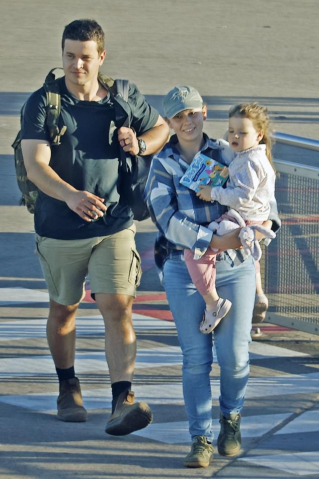 Bindi Irwin, 25, was a devoted mother as she held her two-year-old daughter Grace Warrior while walking through Brisbane Airport on Monday