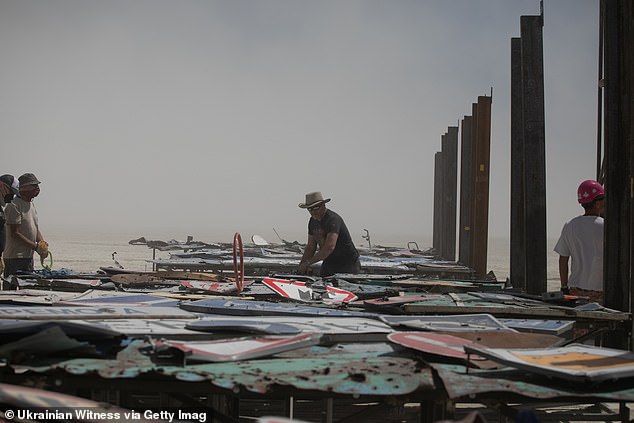 Image shows the installation of the 'I'm Fine' sculpture by Ukrainian artist Oleksiy Sai, at the Burning Man Festival in Black Rock Desert on August 22, 2024 in Black Rock City, Nevada. Burning Man is a week-long, large-scale desert event focused on art and self-expression, featuring a variety of installations, held annually in Nevada