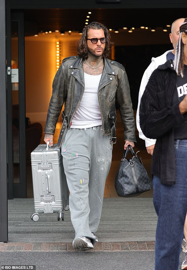 Pete Wicks, 36, wore paint-splattered gray pants and a white T-shirt under a distressed black leather jacket as he carried two bags out of his London hotel