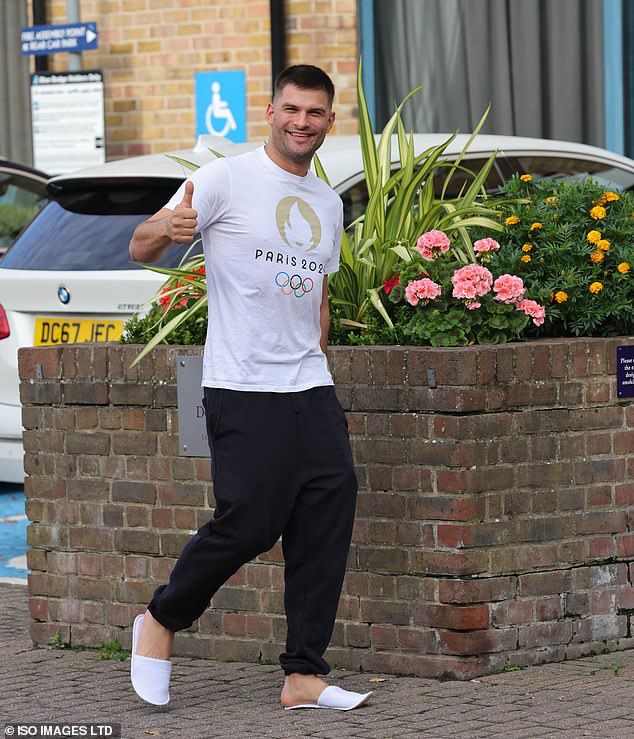 Aljaž Škorjanec appeared in good spirits as he arrived in Paris in an Olympic uniform, giving photographers a thumbs up as he walked to the car, still wearing his white hotel slippers.