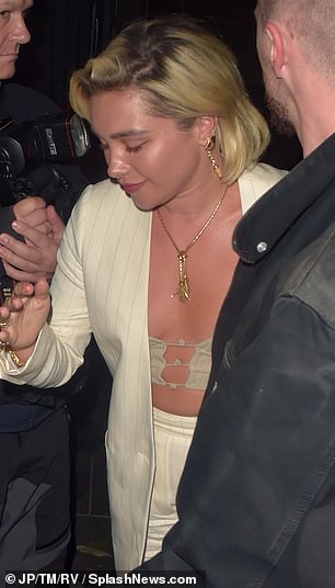 Florence, 28, looked stunning during the outing, showing off her figure in a barely-there bralette paired with a cream suit