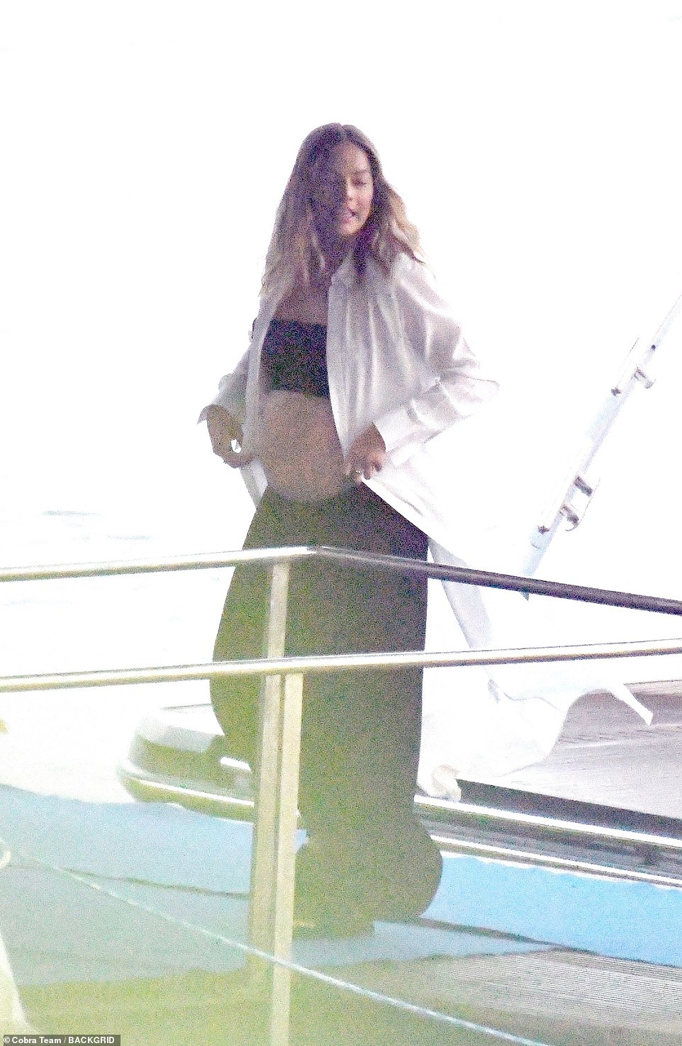 The 34-year-old Barbie star, who has been joined by celebrities aboard the luxury ship in recent days, showed off her growing baby bump in a black bandeau top on the ship called Multiverse