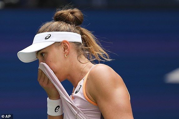 Beatriz Haddad Maia of Brazil wipes sweat from her face during the second set against Karolina Muchova of the Czech Republic, during the quarterfinals of the US Open tennis championship, Wednesday, Sept. 4, 2024, in New York. (AP Photo/Kirsty Wigglesworth)