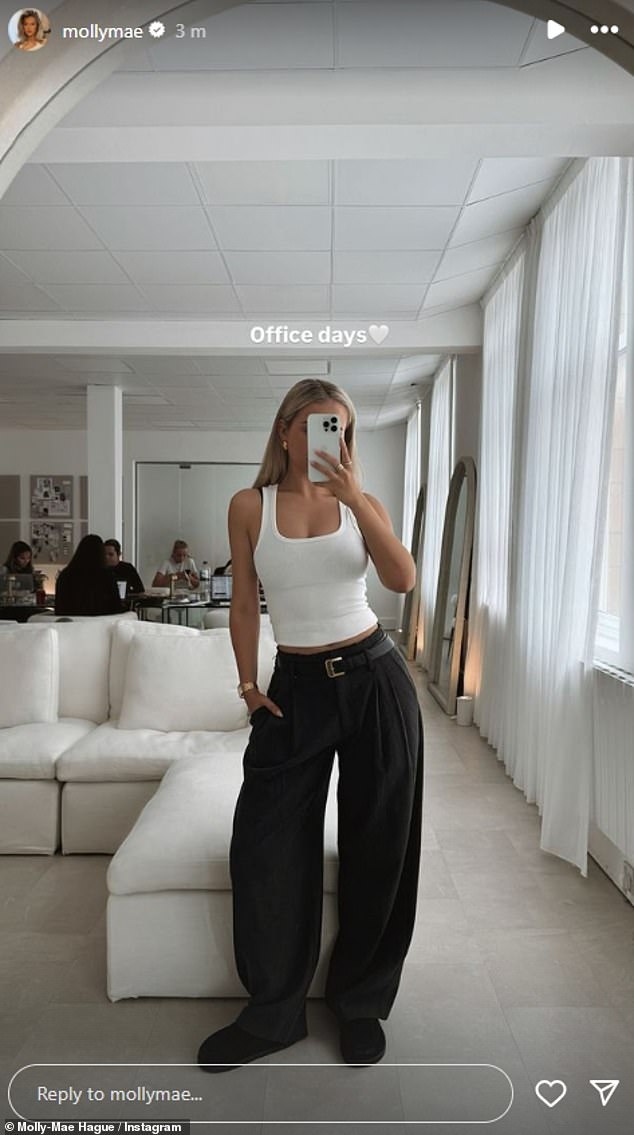 Later in the day, Molly-Mae shared a mirror selfie from the office on her Instagram, where a group of people could be seen hard at work in the background, dressed in the same outfit.