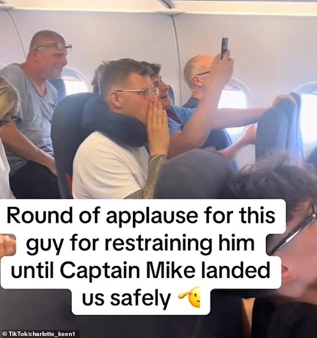 A source told The Sun, who relived the incident: 'The cabin crew were amazing and very brave, but the whole drama was very sad (Pictured: cheering passengers)