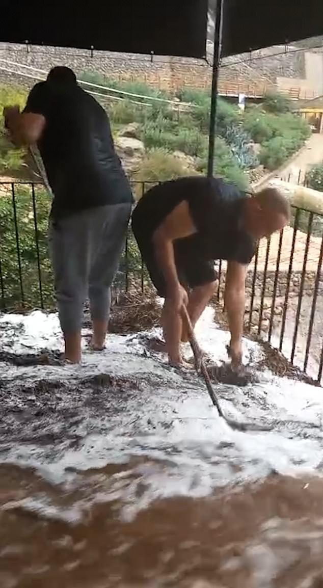 A video obtained exclusively by MailOnline shows a foaming torrent of water flowing through the Es Port restaurant on the seafront at the mouth of the River Pareis.