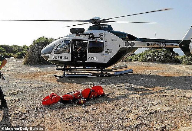 The two British hikers went missing during a storm and are believed to have been caught in heavy rain, causing severe flooding in parts of the island. Pictured: Guardia Civil on the ground in the Tramuntana Mountains)