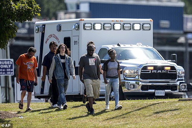 Students and parents leave the campus of Apalachee High School