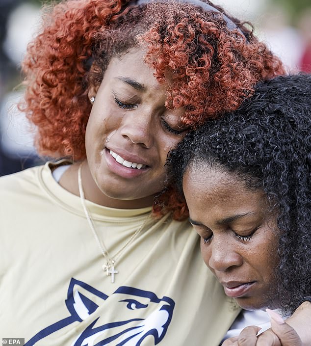 People gather during a vigil for the victims of a school shooting that took place earlier today at Apalachee High School in Winder, Georgia, U.S., September 4, 2024. According to the Georgia Bureau of Investigation, four people were killed, nine people were injured and the suspect is in custody.