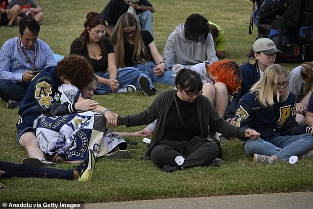 Students and residents remember those who lost their lives by lighting candles at the scene of the Apalachee High School mass shooting on Sept. 4