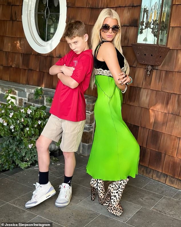 Simpson - whose style icon is Dolly Parton - dressed her slim 5ft 7in figure in a green midi dress under a black bolero and leopard print boots as she posed with her children in uniform