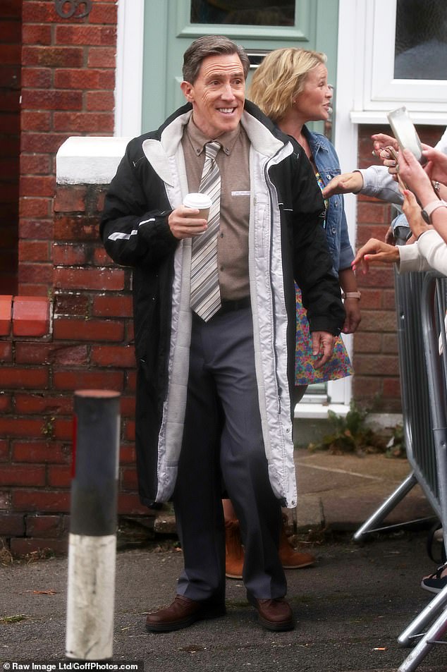 Meanwhile, Rob, 59, who played Bryn West in the BBC sitcom, looked handsome in a brown and grey suit which he paired with a fleece-lined winter coat