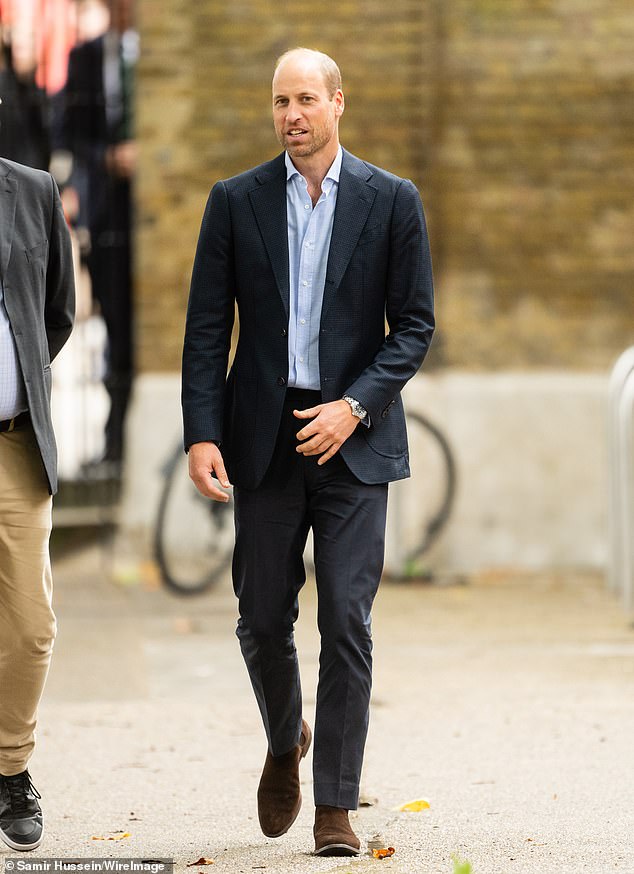 William looked tough yet stylish in a formal suit as he met the artists behind the exhibition