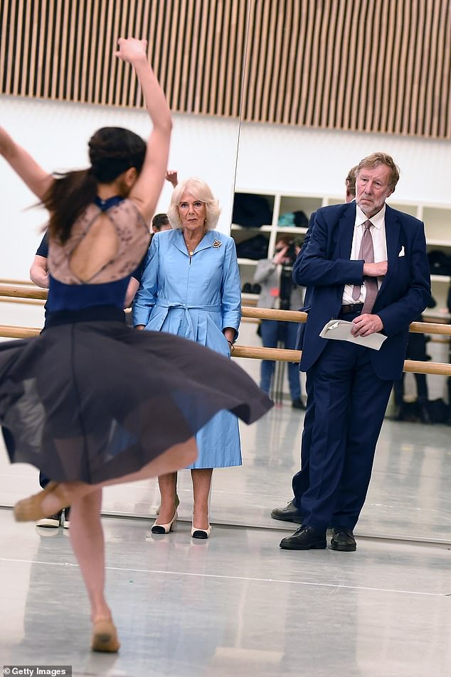 The Queen and the chairman of The English National Ballet, Sir Rupert Gavin, watch a ballerina rehearse in the studio