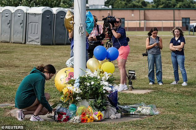 A temporary memorial has been created using a wreath and flowers